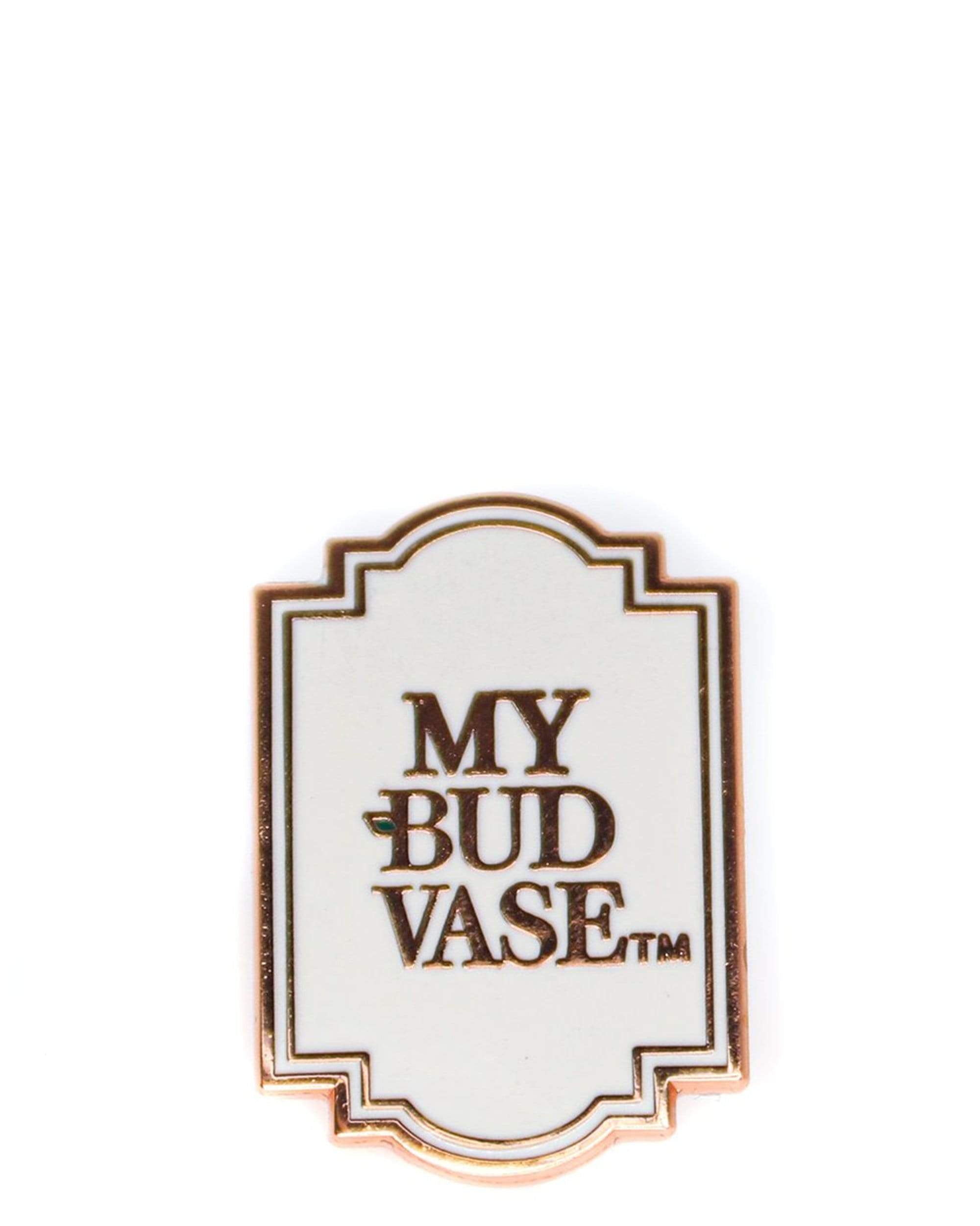 A close-up of the Logo Pin, a silver-colored pin featuring a simple, minimalist design. A close-up of the Logo Pin, a silver-colored pin featuring a simple, minimalist design.