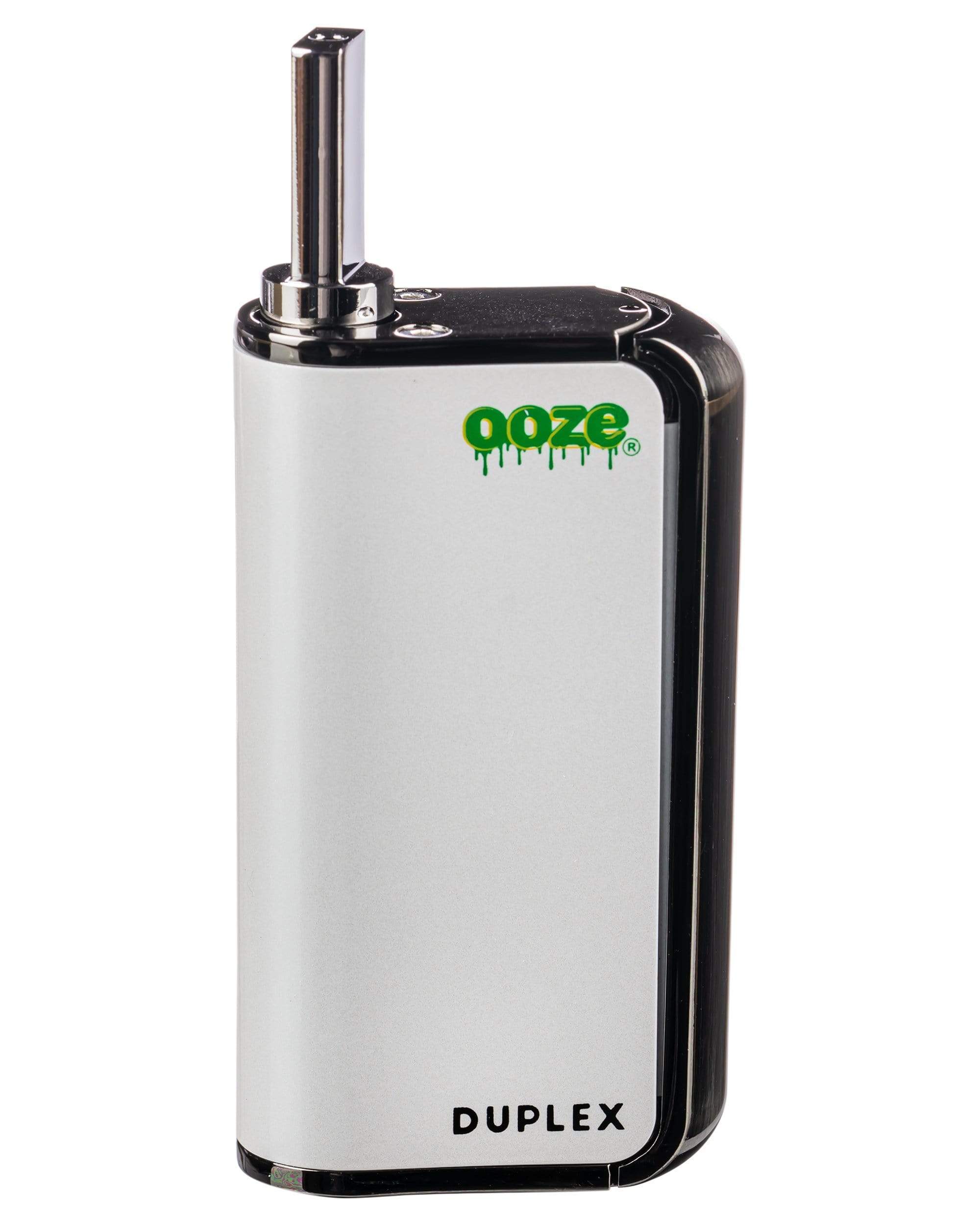 Front view of the Duplex Dual Extract Vaporizer, a sleek, black device with a silver mouthpiece, against a plain white background. Front view of the Duplex Dual Extract Vaporizer, a sleek, black device with a silver mouthpiece, against a plain white background.