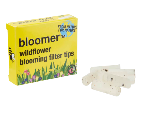 A stack of white Wildflower Blooming Wax Filter Tips, displayed against a plain white background in a slightly angled overhead view. A stack of white Wildflower Blooming Wax Filter Tips, displayed against a plain white background in a slightly angled overhead view.