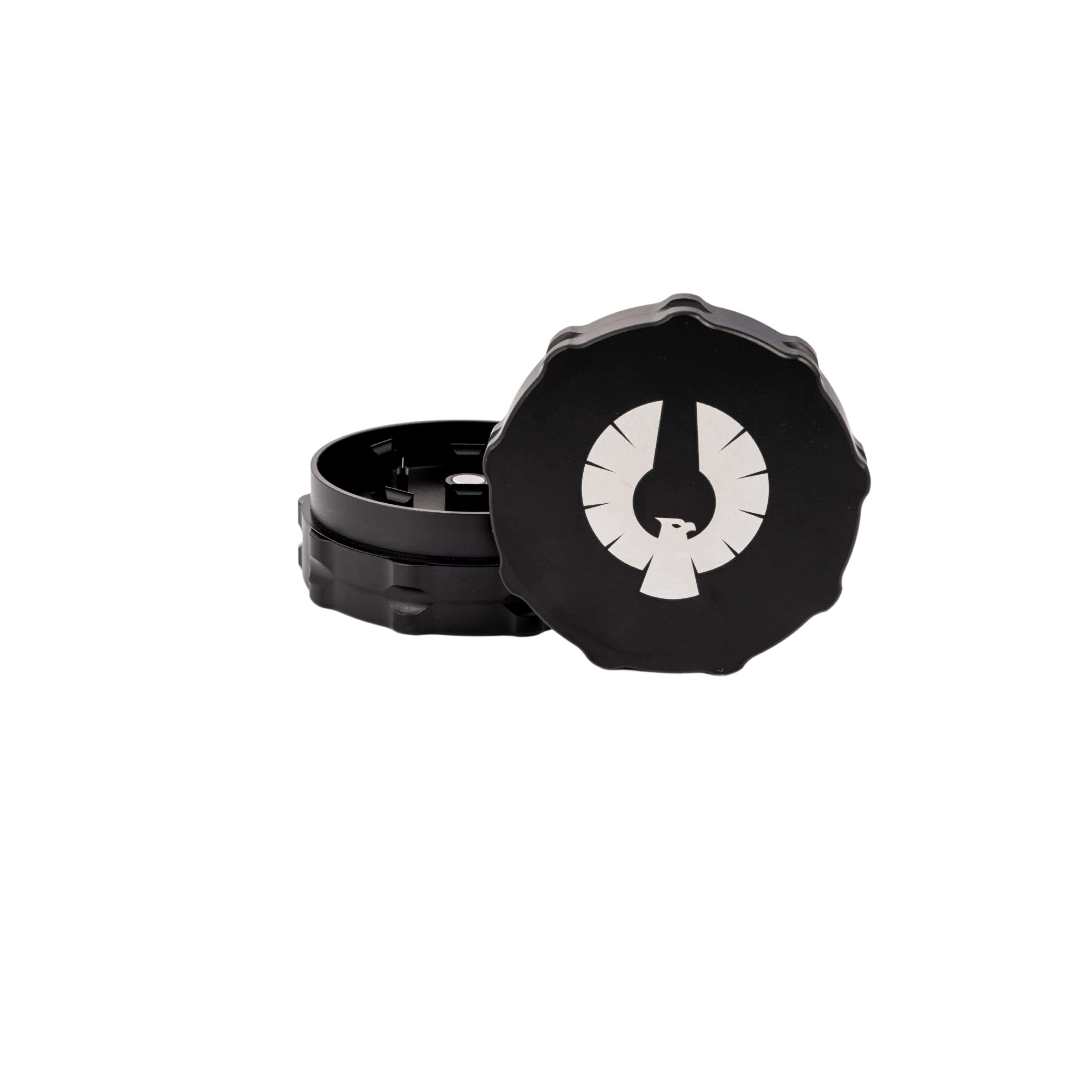 An overhead view of the 2 Piece Medium Grinder, with its two metallic sections slightly separated on a neutral background. An overhead view of the 2 Piece Medium Grinder, with its two metallic sections slightly separated on a neutral background.