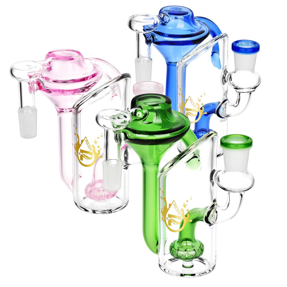 Front view of the Alchemist Recycler Ash Catcher in blue and pink glass, showcasing its rounded, layered design. Front view of the Alchemist Recycler Ash Catcher in blue and pink glass, showcasing its rounded, layered design.