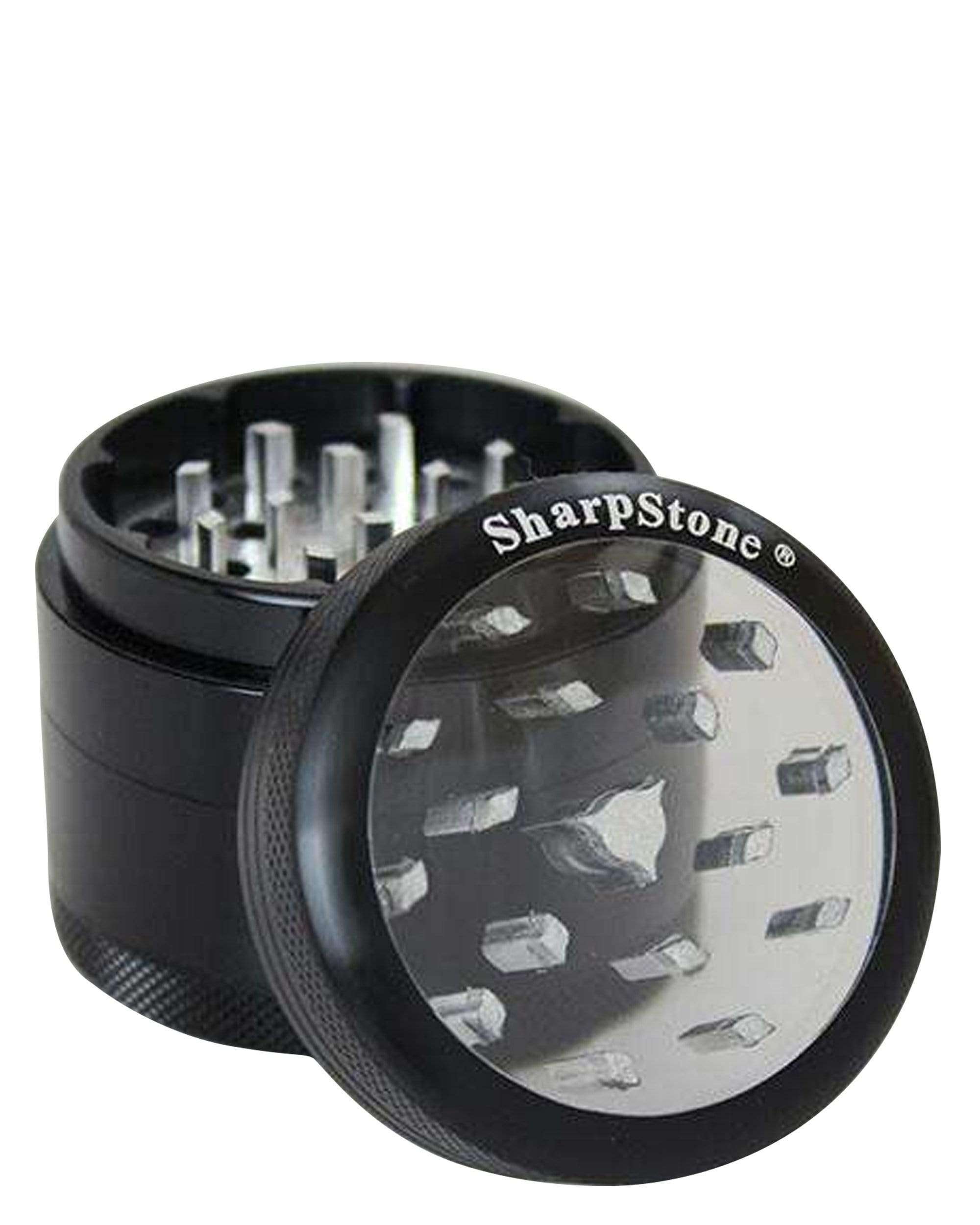 A close-up of the Classic Clear Top Grinder, showcasing its metallic finish and clear acrylic top, partially open to reveal internal grinding teeth. A close-up of the Classic Clear Top Grinder, showcasing its metallic finish and clear acrylic top, partially open to reveal internal grinding teeth.