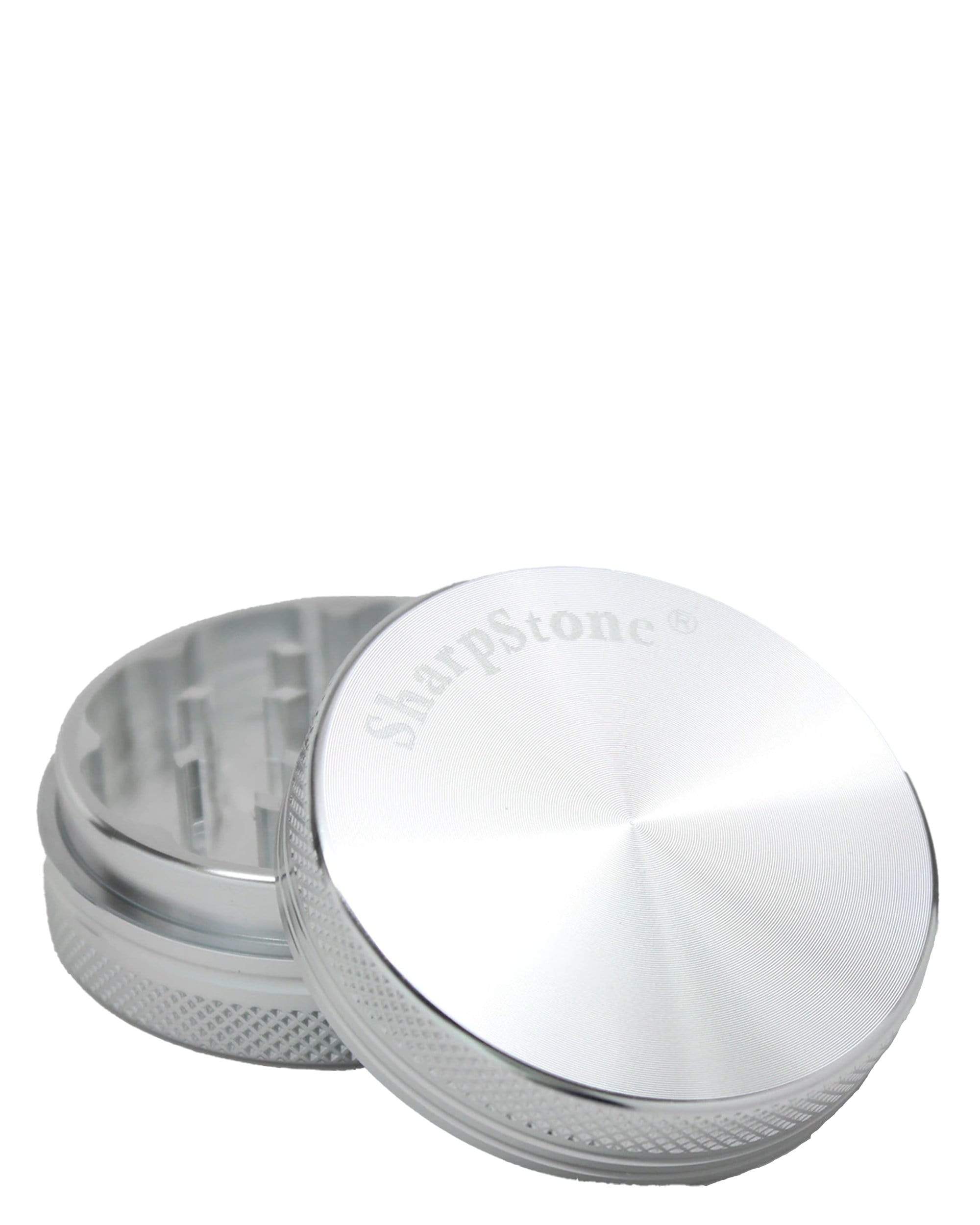 A close-up of the two-piece grinder, displaying its metallic, disassembled components against a plain white background. A close-up of the two-piece grinder, displaying its metallic, disassembled components against a plain white background.