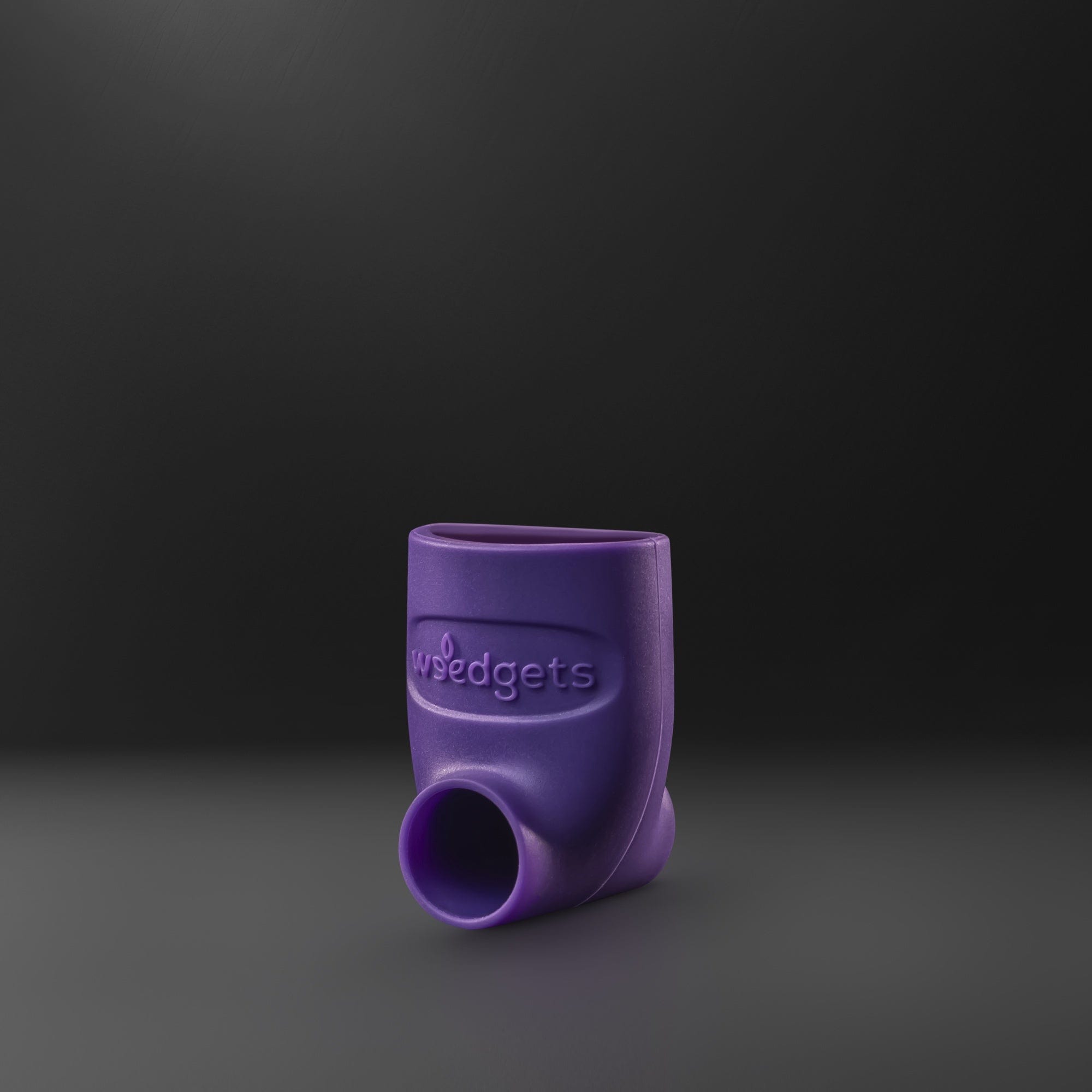 Front view of the SILI-SCOOP Bowl Loading & Tamping Tool, a purple silicone tool against a dark background. Front view of the SILI-SCOOP Bowl Loading & Tamping Tool, a purple silicone tool against a dark background.