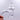 Close-up of the Quartz Banger Kit, displaying the clear glass banger held between fingers against a blurred background.