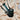 A close-up, angled view of the Twenties Collection Hand Pipe, showing the dark glass pipe against a textured, light-colored background.