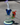 A low-angle view shows the Drain Incycler Rainbow Color Glass Rig with a colorful glass body and circular base on a gray surface.