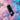 Angled close-up of the Cloudious9 Atomic9 Vaporizer floating through pastel pink and blue clouds with water droplets and streaked light.
