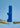 A front view of the blue Stage 1 Joint Case, positioned among rolled joints on a solid blue background.
