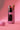 A close-up, angled view shows a joint nestled inside the Stage 1 Joint Case, against a solid pink backdrop.