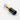 Close-up side view of the SakiBomb Lipstick Chillum, a gold and dark-colored chillum resembling a lipstick tube.