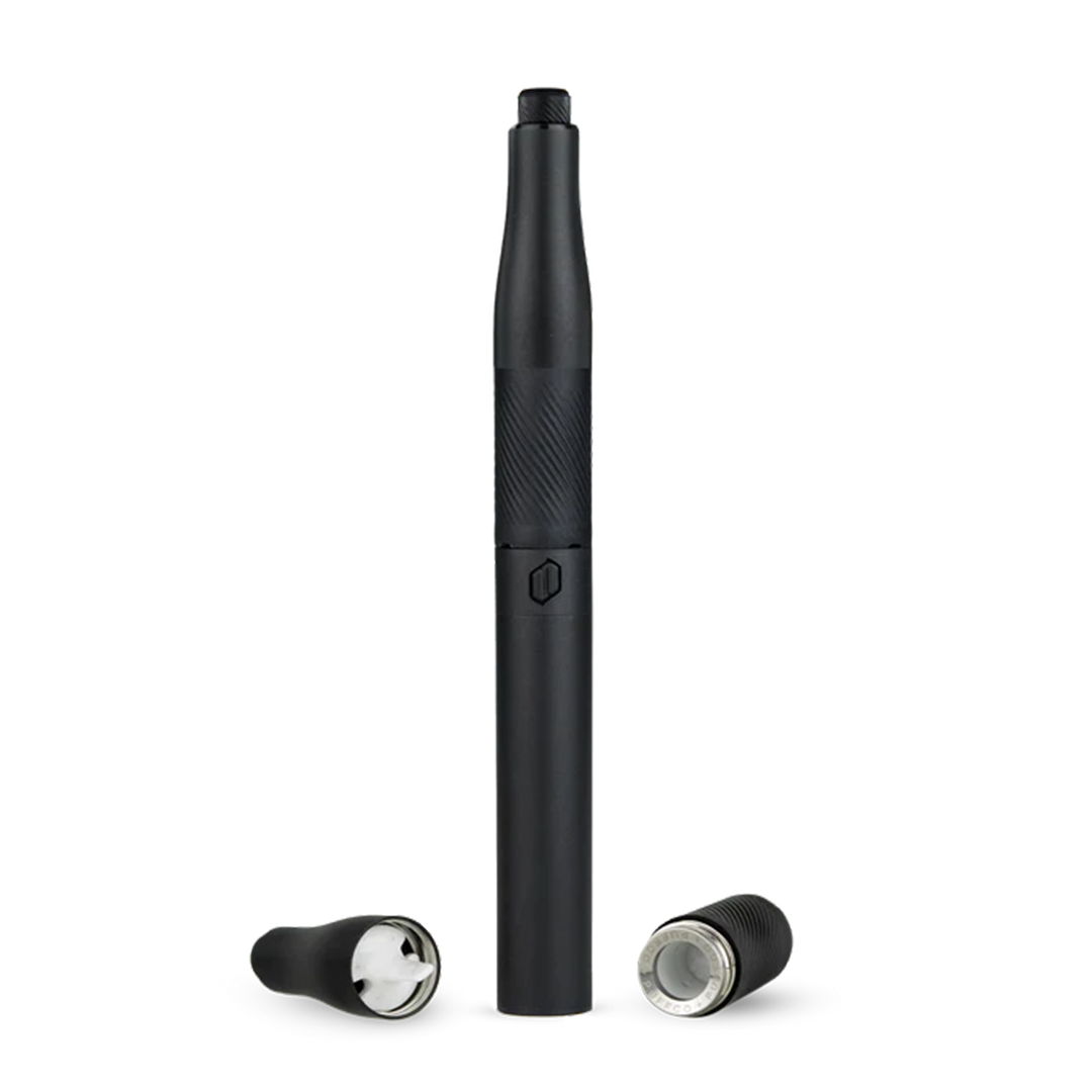 A close-up, angled view of the Puffco New Plus Vaporizer, showing its black cylindrical shape and two accompanying attachments.