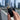A hand holds the black Stage 2 Joint Case against a blurred city skyline, showcasing its cylindrical shape.