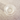 A top-down view of the Twenties Collection Ashtray, a small, clear glass dish on a textured surface.