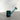 A side view of the Twenties Collection Hand Pipe, showcasing its smooth, blue glass construction against a neutral background.