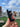 A close-up shows the Stage 1 Joint Case held against a blurred city background, displaying its sleek, dark design.