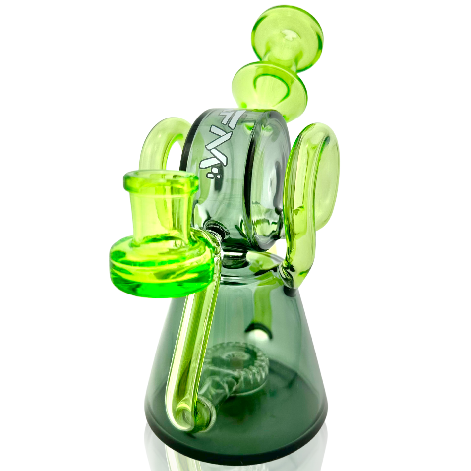 A three-quarter view of the Double Ram Recycler Rig, showcasing its green glass construction and intricate bubbler design.
