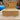 The Treasure Chest (XL Stash Box) sits open on a wooden surface, revealing its interior against a blurred backyard backdrop.