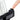 A close-up, angled view of the New Peak Vaporizer’s mouthpiece, touched by a fingertip, with a blurred clear glass body.