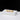 A front-angle view of the gold ONGROK Aluminum and Glass Chillum Pipe resting on a white pedestal against a black backdrop.