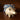 Front view of Helen the Hedgehog Pipe, a ceramic piece with a patterned cloth behind it on a dark surface.
