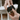 A close-up shows hands examining the Grinder, highlighting its detailed metallic construction and cylindrical shape.