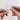 Close-up of “The Bong” joint, showcasing the clear glass connection between pieces, held by two hands.