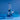 The Bong stands on a blue surface, highlighted by a unique angled shot with a clear glass body.