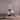 The Bong is displayed in a low-angle shot on a reflective surface, alongside clear geometric shapes.
