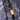 Close-up of The Explorer - Smell Proof Backpack’s zipper pull, with a golden lock securing the dark-colored bag.