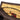 Close-up interior view of the Revelry Supply The Overnighter - Smell Proof Small Duffle showing yellow lining, a zipper pocket, brass zipper pull, and leopard-print exterior.