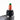 A close-up shows the Sriracha Bottle Puffco Peak Pro carb cap resting on a black surface, mimicking the iconic hot sauce bottle.