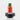 A close-up, angled view of the Sriracha Bottle Puffco Peak Pro carb cap in red, resting on a black surface.
