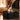 A close-up shows a hand holding the Cache Debowling Ashtray above a dark, reflective surface, highlighting its modern design.