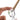Close-up of a hand holding the clear glass MJ Arsenal Martian Blunt Bubbler at an angle, white background and a visible brown blunt inserted.