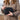 A person holds the Carbon-lined Locking Wallet in their hands against a blurred, outdoor background.