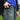 A close-up shows the 2 Piece Magnetic Grinder peeking out from a blue shirt pocket, with a blurred green background.