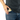 A close-up shows the Aluminium Storage Puck in a pocket, highlighting its sleek, round shape and metallic finish.