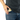 A close-up shows the Aluminium Storage Puck in a pocket, highlighting its sleek, round shape and metallic finish.