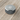 A front view of the Aluminium Storage Puck, showcasing its sleek, circular design on a wooden surface.