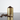A close-up, eye-level view of the Aluminum Metal Storage Jar, surrounded by scattered coffee beans on a dark surface.