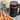 A close-up, angled view showcases the Botanical Infuser Kit surrounded by small, colorful, decorative edible flowers.
