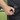 A close-up, angled shot shows the Premium Storage Tube held against a textured black background.