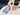 A hand holds the 5 Piece Storage Grinder against a blurred background with colorful text visible on the surface below.