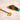 A close-up, angled view of the Scored Gummy Molds in bright colors, partially sliced by a silver knife on a pale surface.